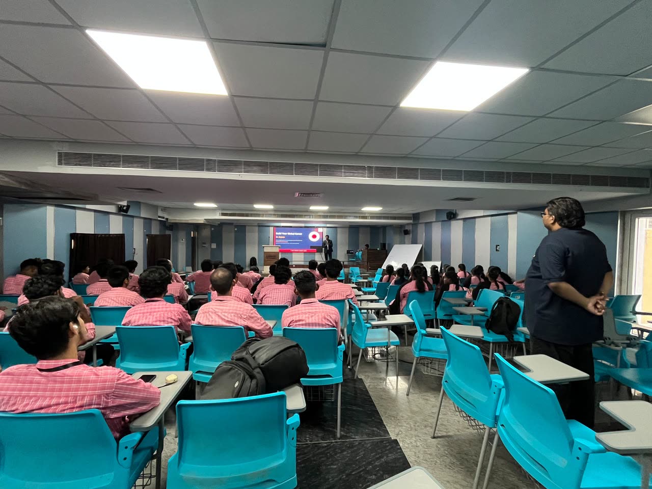 Trainer addressing students in a seminar hall
